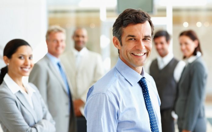 Smiling: Group of satisfied business people